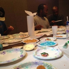Participants at a table with plates of sprinkles used to decorate holiday cookies.