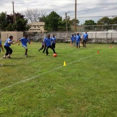 Participants in the middle of a game of soccer.