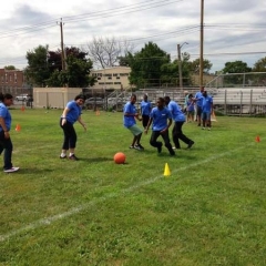 Out in a field, participants enjoying a game of soccer.