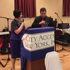 Sophia presents the award to Alvin Suarez, a Los Ciegos Del Barrio band member.