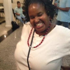 A happy participant showing off her new necklace.
