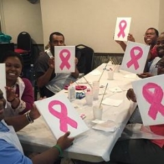 Participants holding up pink ribbons.