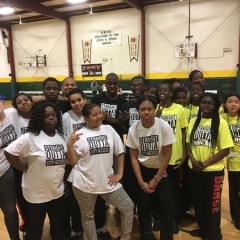 The team wearing "Straight outta City Access" shirts gathers for a photo.