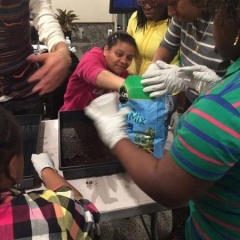 Participant reaching into a bag with soil.