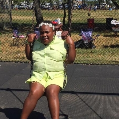 A participant smiles on a swing.