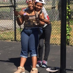 Participants hug by the swings.