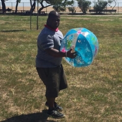 A participant holding a large inflatable beach ball.
