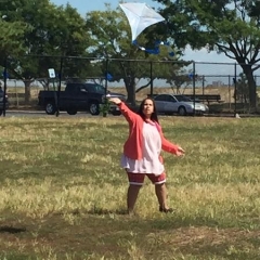 A participant running with a kite.