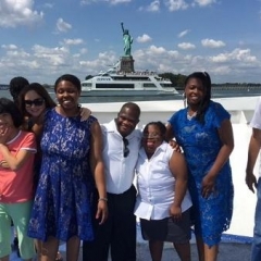 Participants pose in front of Statue of Liberty.