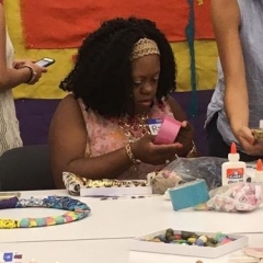 A participant concentrates on making the mural.