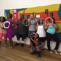 Participants pose in front of the mural.