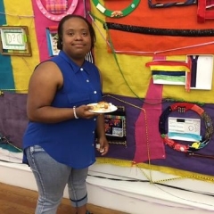 A participant poses in front of the completed mural.