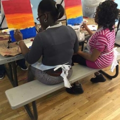 Two participants learning painting techniques.