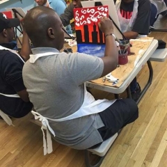 A participant adding final touches to his painting.