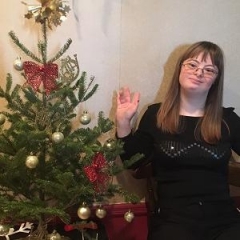Participant posing with a Christmas Tree.