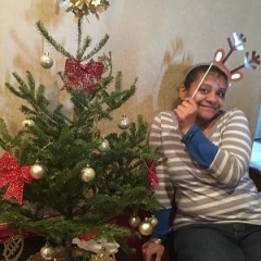 Participant holding up holiday props.