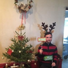 Participant holding up holiday props.