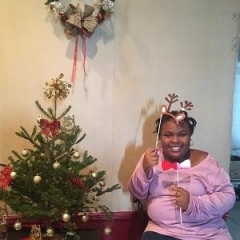 Participant holding up holiday props.