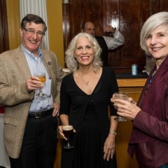 Randy Bolton in the center poses with Ciri Malamud (Horticultural Therapist) on her right and Thomas Malamud on her left.  ID: The group, holding up drinks, smiles for the camera.