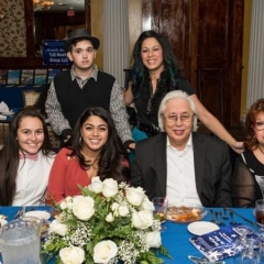 Lana Titta with friends and family.  ID: The group poses for the picture.