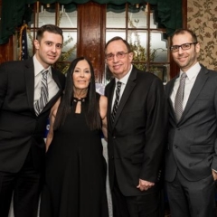 Ilene Rosen poses with family members.  ID: Eric Rosen, event honoree, is on the left.