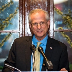 Edward Burke, Staten Island Deputy Borough President.  ID: Edward is speaking at a podium while accepting an award.