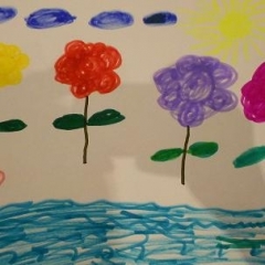 A drawing made for the art contest.  ID: A picture of flowers, clouds, and an ocean in the front.