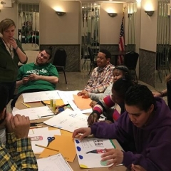 Participants drawing while listening to the teacher.