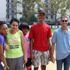 Participants smile for the camera.  ID: A group of participants standing outdoors