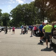 Event participants getting into golf carts.