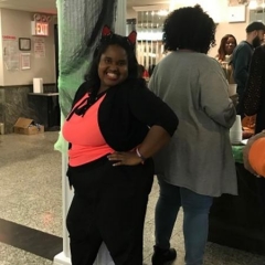 Participant smiles for the camera.  ID: She is wearing a cat woman costume.