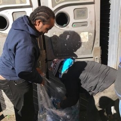 Participants loading recycling machine.
