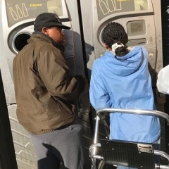 Participants figuring out how to use the recycling machine.