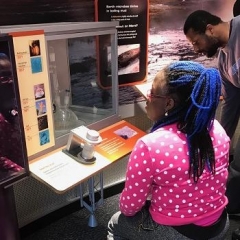 A participant reads about an exhibit.