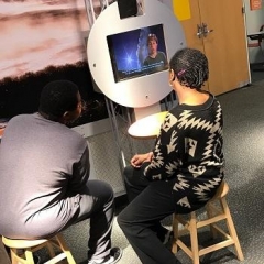 A participant is listening to an educational video.
