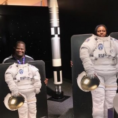 Participants pose with astronaut flight suits.