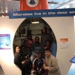 Participants pose in front of Deep Sea exhibit.