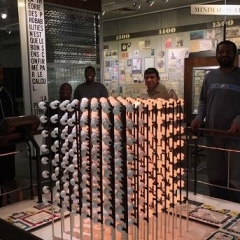 Participants pose in front of an exhibit.