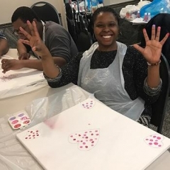 Participant finger painting in preparation for Valentine's Day.