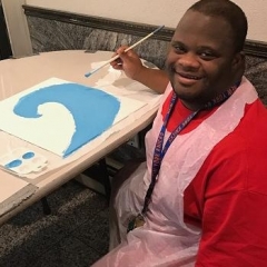 A participant paints in preparation for Valentine's Day.