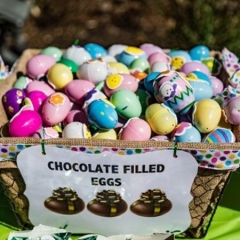 Easter Egg basket.  ID: The sign on the basket reads "Chocolate filled eggs."