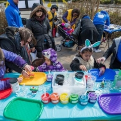 Kids playing at the arts and crafts table.  ID:  Kids are wearing various bunny costumes.