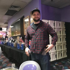 Bowl-A-Thon attendee.   ID: The attendee is smiling for the camera.