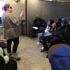 Holly Bonner stands before the participants reminding them to "pause before they post."