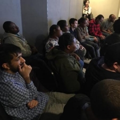 ID: A group of participants engrossed in the presentation.