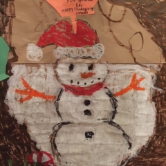 A snowman as part of a larger mural made by the participants.  ID: Snowman drawn at the center of the artwork.