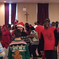 Participants mingle and dance after the performance.  ID: Participants dressed in holiday themed colors.