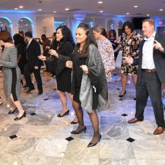 Attendees line dancing at the 2019 Achievement Dinner & Auction Gala