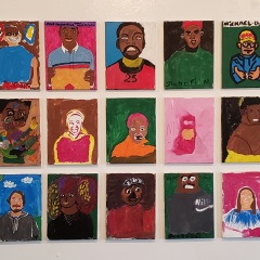 Self portraits displayed on the wall.