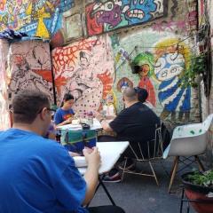 Participants enjoy refreshments in the colorful yard of The Living Gallery.